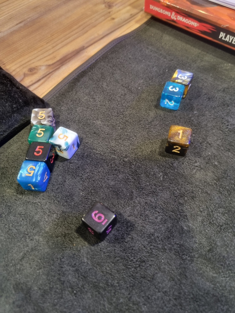 Nine d6 have been rolled on a mat to cast fireball. The dice add up to 38, not bad! The corner of a player's handbook is visible at the edge of the shot.
